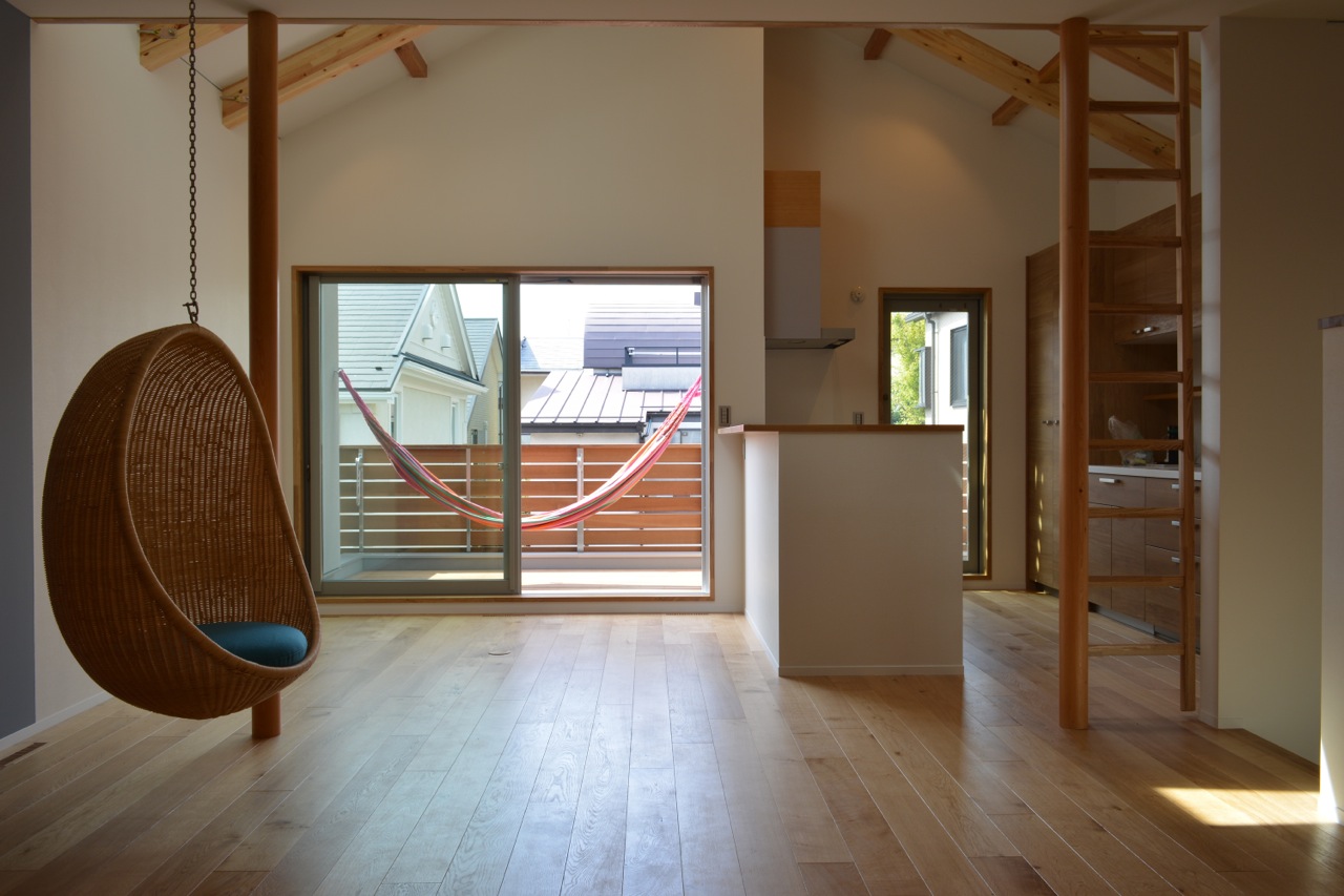  View of the dining and kitchen area with hanging chair. 